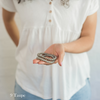 Woman holding companion bracelets in palm