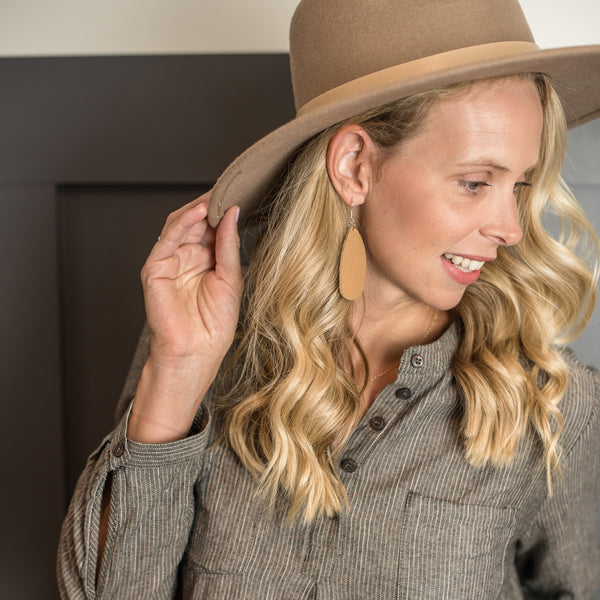 Woman wearing brown comfort earrings