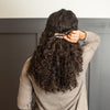 Woman adjusting adorn hair clip