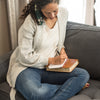 Woman writing on blank verse cards