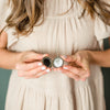 Woman wearing silver locket necklace