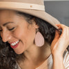 Woman wearing pink comfort earrings