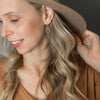 Woman wearing No. 139 silver earrings with glass stones