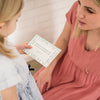 Girl reading a verse card to woman